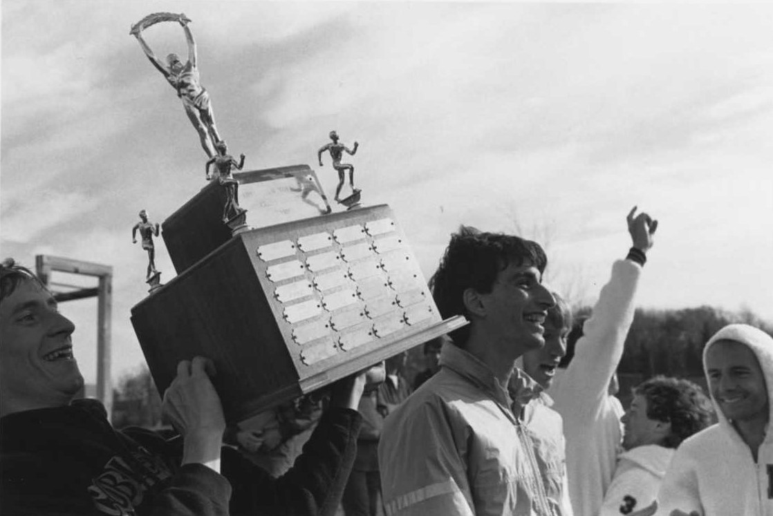 Paul Ruston and his teammates holding up a sports trophy